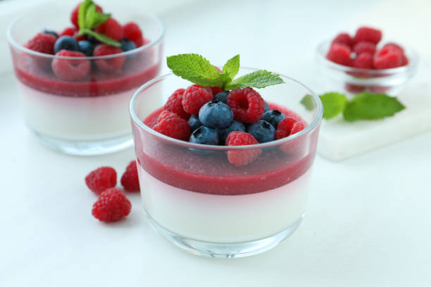 istock Delicious panna cotta with berries on white table 1397685132