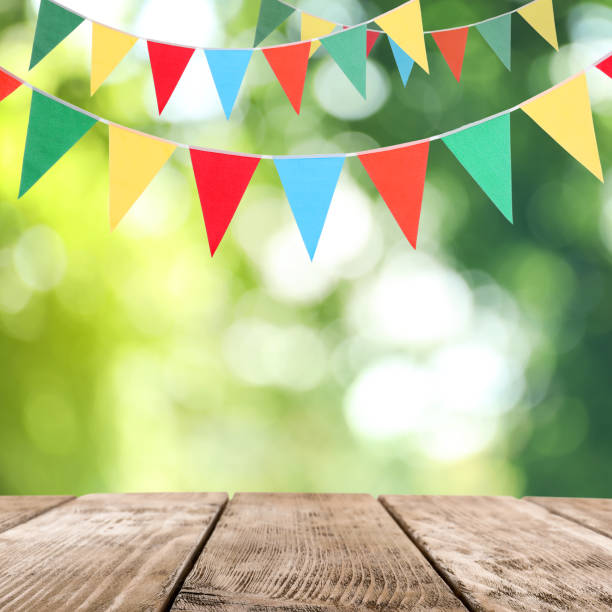 istock Empty wooden table and decorative bunting flags outdoors 1397685368