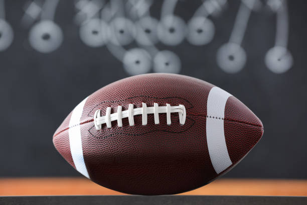 istock American football ball against blurred game scheme 1397686941