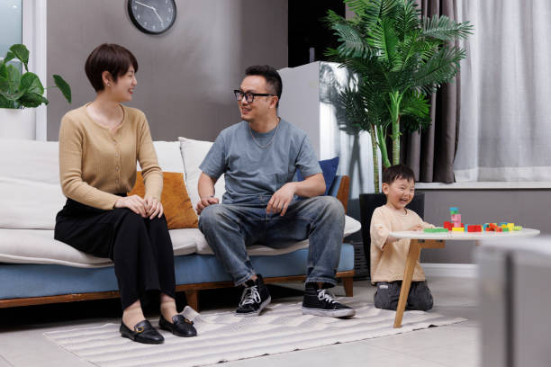 istock The young couple were chatting on the sofa while their son was playing 1397688135