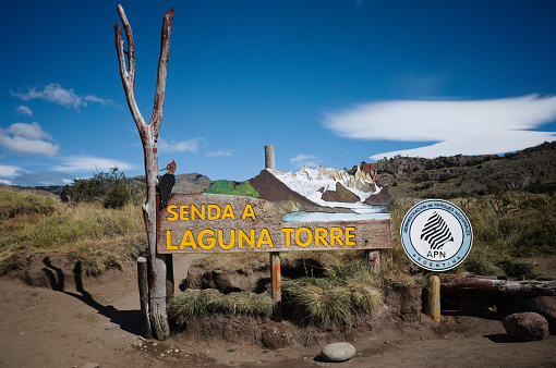 Sign board with inscription Senda a Laguna Torre means Path to Lake Torre. Beginning of hiking trail to Laguna Torre Lake in Los Glaciares National Park near El Chalten, Patagonia, Argentina