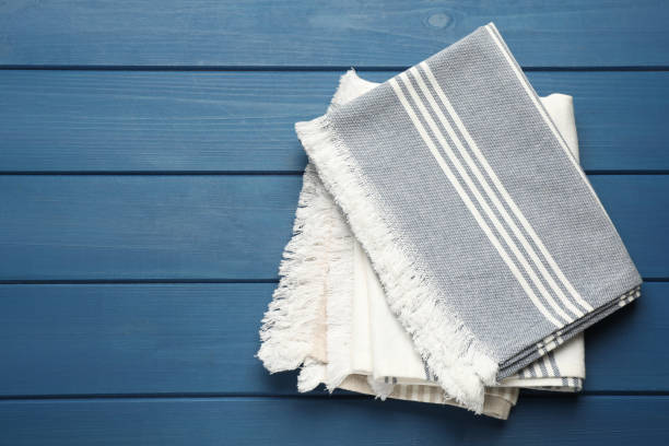 istock Striped kitchen towels on blue wooden table, top view. Space for text 1397689796