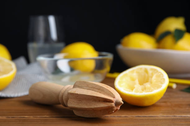 istock Citrus reamer and fresh lemons on wooden table 1397689895