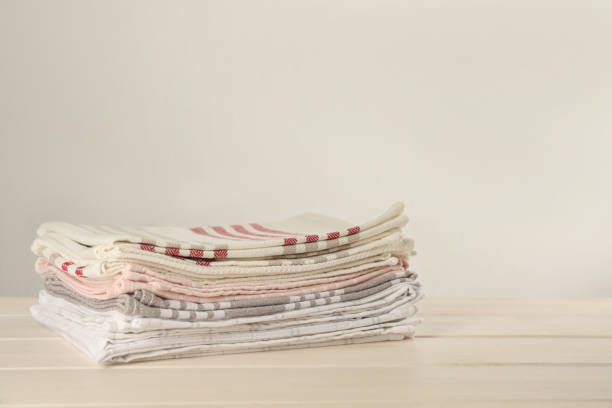 istock Stacked kitchen towels on white wooden table, space for text 1397689927