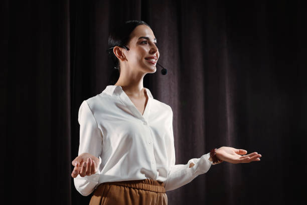 Motivational speaker with headset performing on stage