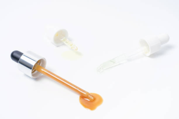 istock Three pipettes with serum and collagen on white background close-up. 1397690932