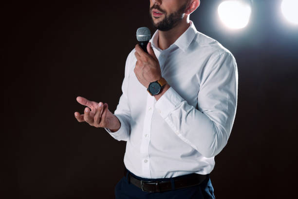 istock Motivational speaker with microphone performing on stage, closeup 1397691210