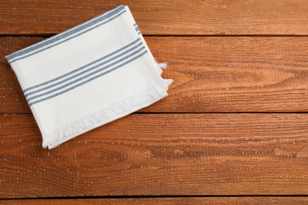 istock Striped kitchen towel on wooden table, top view. Space for text 1397691963