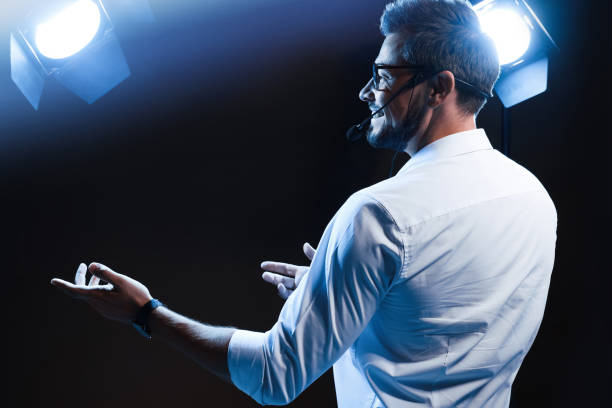 istock Motivational speaker with headset performing on stage 1397692034