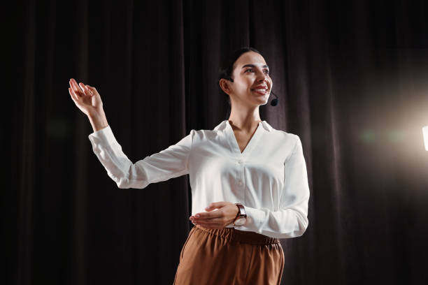 istock Motivational speaker with headset performing on stage 1397692076