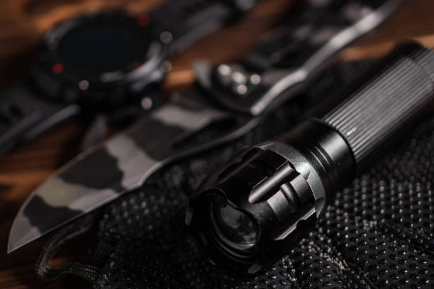 istock Everyday carry EDC items for men in black color - flashlight, watch and knife. Survival set. Minimal concept. 1397692221