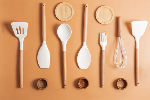 istock kitchen background. Silicone white cooking tools with wooden handle on a brown background. top view. flat lay. 1397693229
