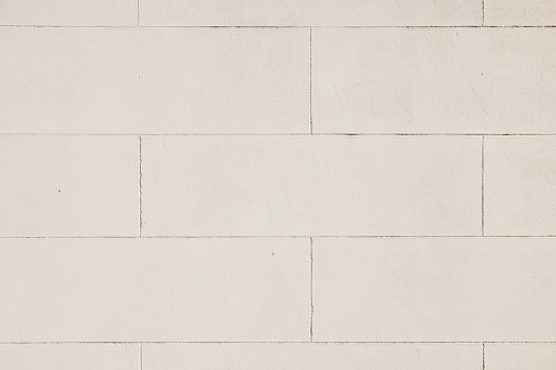 Close-up on a cream colored concrete block wall.