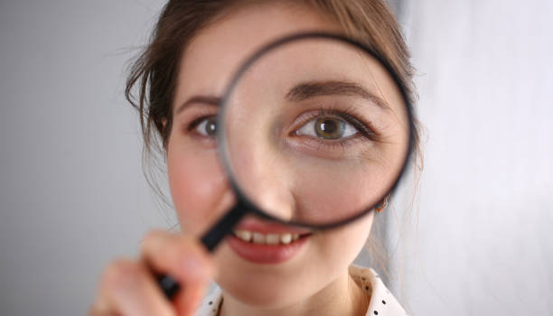 istock Young woman look through magnifying loupe, interested in everything 1397694881