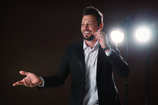 Motivational speaker with headset performing on stage