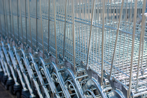 A lot of shopping trolleys. Modern supermarket shopping carts in a row.