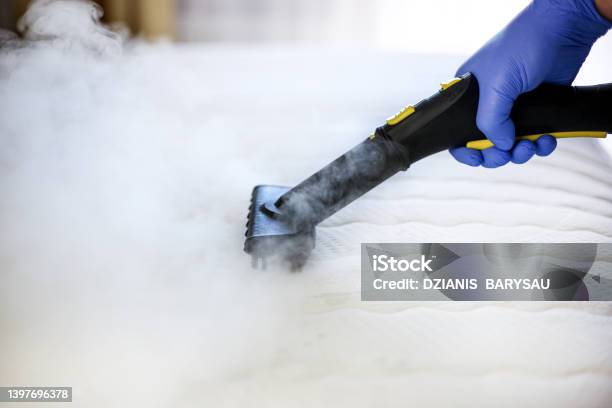 Cleaning And Disinfection Of The Mattress In The Bedroom With Hot Steam Professional Cleaning Process Stock Photo - Download Image Now