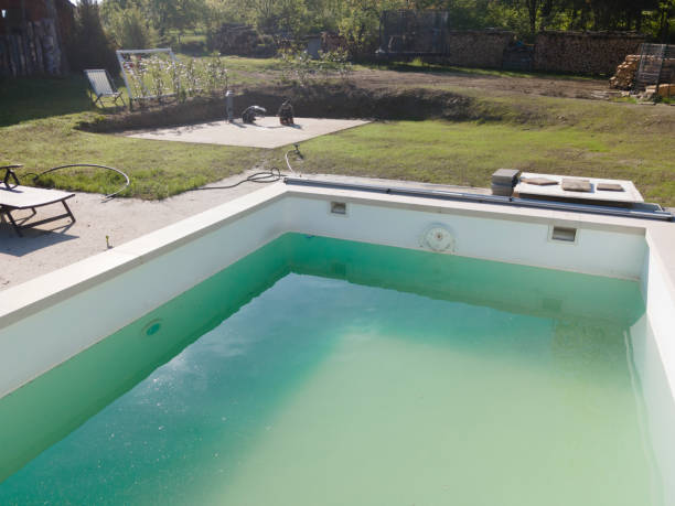 istock Drone flight over pool in the middle of greenery, fresh grass grown 1397697055