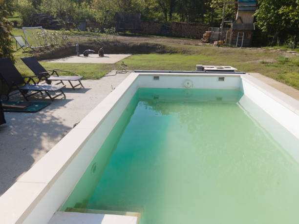 istock Drone flight over pool in the middle of greenery, fresh grass grown 1397697392