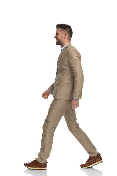 istock side view of attractive man in his 40s smiling and walking 1397697396