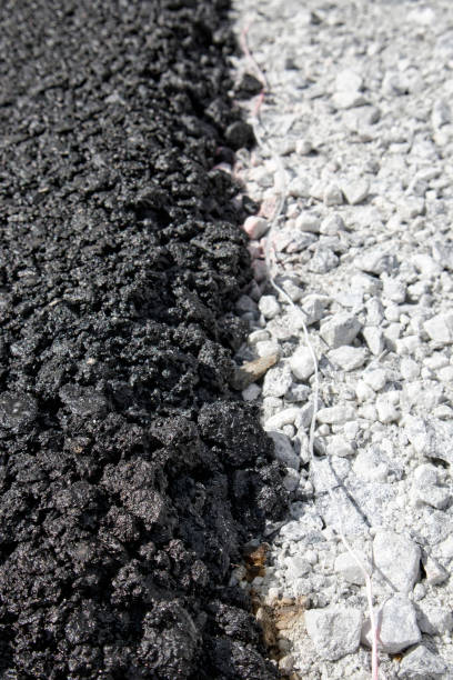 istock layer of fresh black asphalt on grey gravel 1397697490