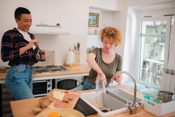 istock Happy lesbian couple doing chores in the kitchen 1397697497