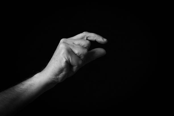 istock Pinching Hand emoji isolated on black background 1397697665