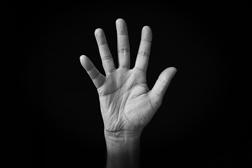 Dramatic black and white image of Hand with Fingers Splayed emoji isolated on black background