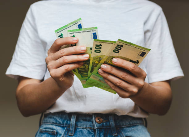 istock One hundred euro paper banknotes in hands. 1397697924