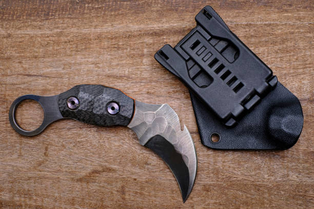 istock Karambit knife tactical fighter on wood background 1397698786