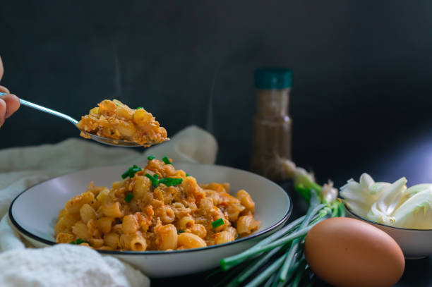 istock The aroma in the spoon is fried macaroni with egg and on top spring onion with raw onion. Vegetarian food for non-meat eaters. 1397699005