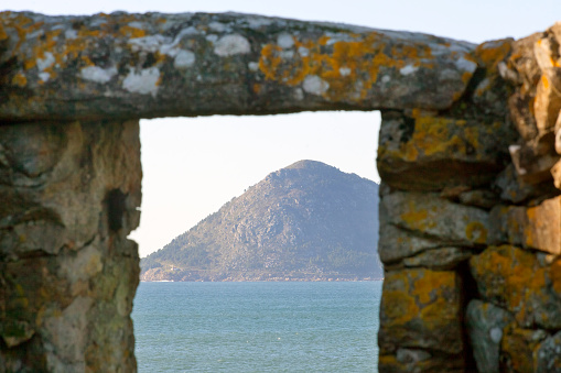 Mount Louro seen from Porto do Son, A Coruña province, Galicia, Spain. Ancient stone window frame.