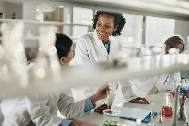 istock Black scientist talking to her colleague in laboratory. 1397700646