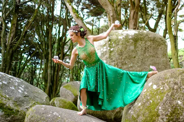 Photo of Green fairy that represents the earth and also represents recycling glass with a glass jar