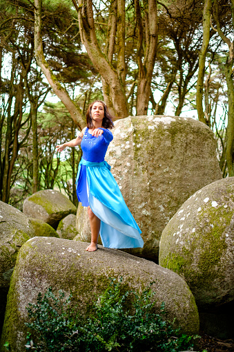 Blue fairy representing the water element dancing in nature
