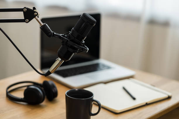 istock Condenser microphone in recording home studio. Content creator working with laptop host streaming radio podcast interview conversation at home broadcast studio recording voice over radio 1397702273