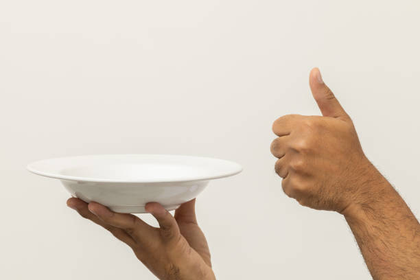 istock Close up hand chef showing empty plate delicious dish menu good taste thumbs up on isolated white background. Cooking man Occupation chef or baker People in kitchen restaurant and hotel. 1397703441