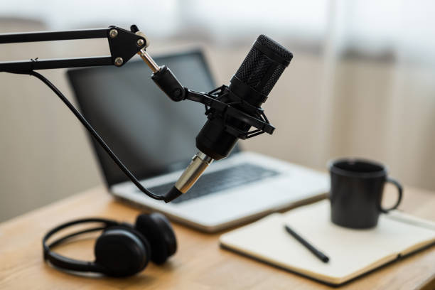 istock Condenser microphone in recording home studio. Content creator working with laptop host streaming radio podcast interview conversation at home broadcast studio recording voice over radio 1397704297