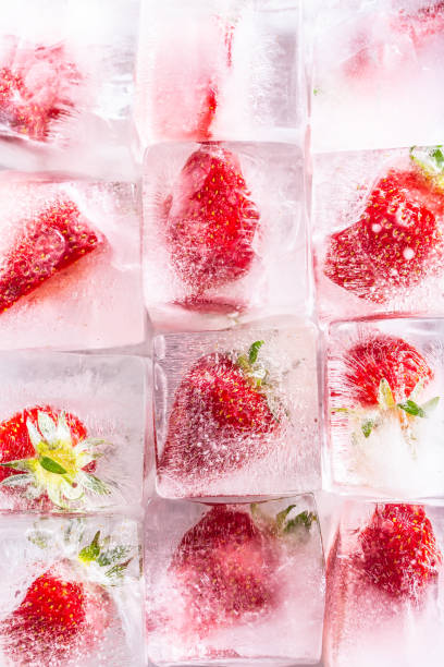 istock Three rows of ice cubes with strawberries - Top of view. 1397704364