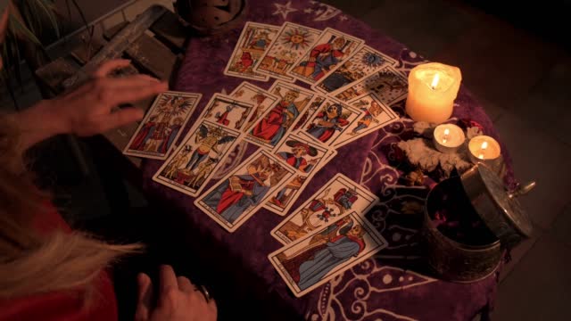 Pythoness spreads the tarot cards all over the table