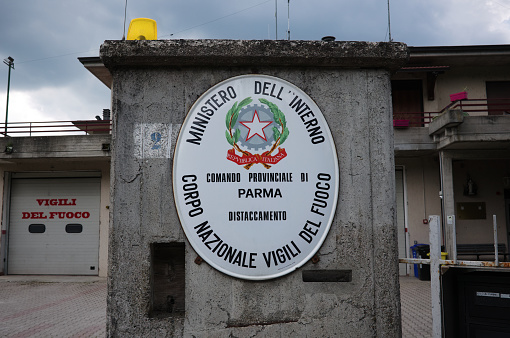 Borgo Val di Taro, Italy - May, 2022: Emblem of national fire brigade of Republic of Italy in Parma province at entrance to fire station. Provincial Command of Parma Detachment of national fire dept