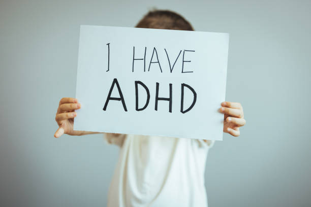 istock Young boy holds ADHD text written on sheet of paper 1397707890