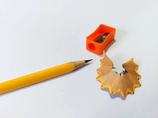 Photo of Pencil with sharpening shavings on white background