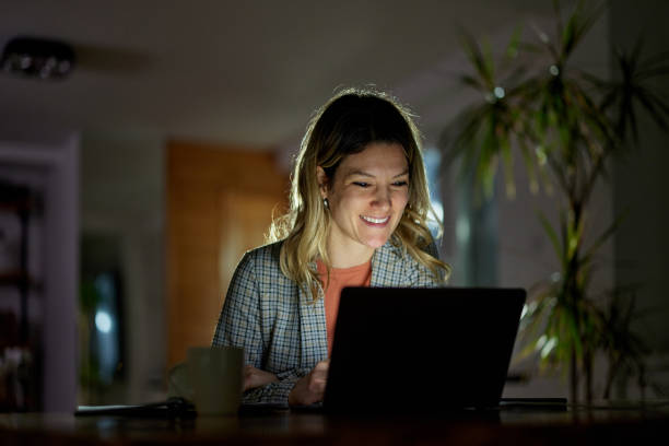 istock Happy businesswoman working on computer late in home office. 1397708137