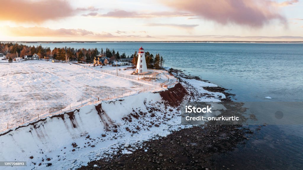 Panmure Island Lighthouse Aerial drone photograph of Panmure Island Lighthouse on Prince Edward Island at golden hour sunset in winter with snow Prince Edward Island Stock Photo