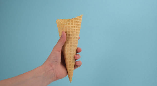 istock Sugar cone, wafer tube on a blue background. 1397708961