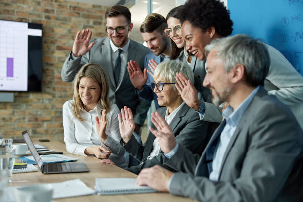 istock Happy business team greeting someone during web conference in the office. 1397709015