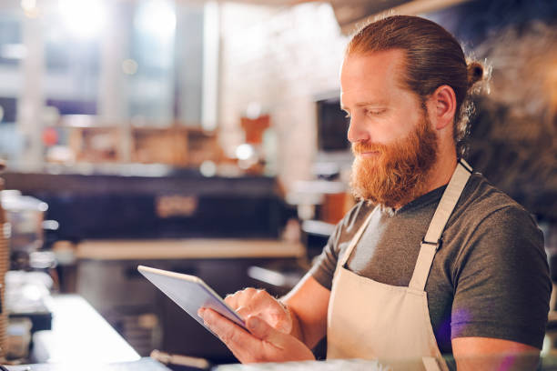 istock Shot of a young man using a digital tablet while working in a cafe 1397709434