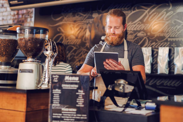 istock Shot of a young man using a digital tablet while working in a cafe 1397709435