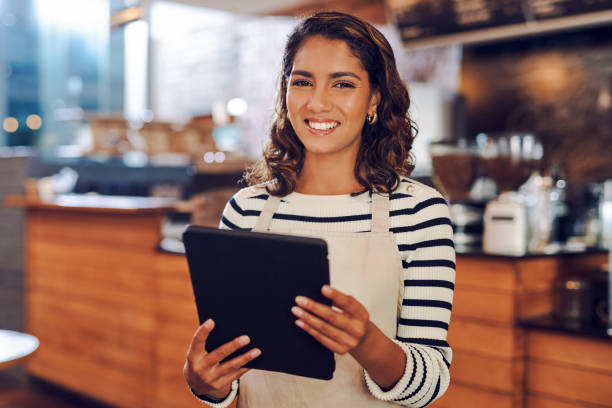 istock Portrait of a young woman using a digital tablet while working in a cafe 1397709996